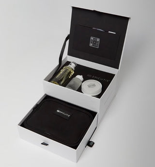 Open Epicutis Holiday Box showing skincare products and a black pouch inside.