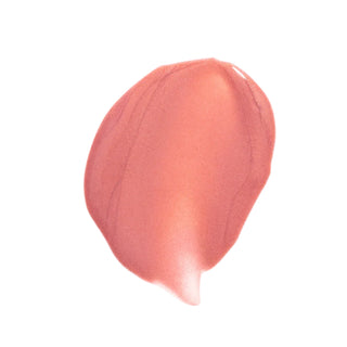 A smooth, teardrop-shaped swatch of sheer, satin blush pink makeup cream on a solid white background.
